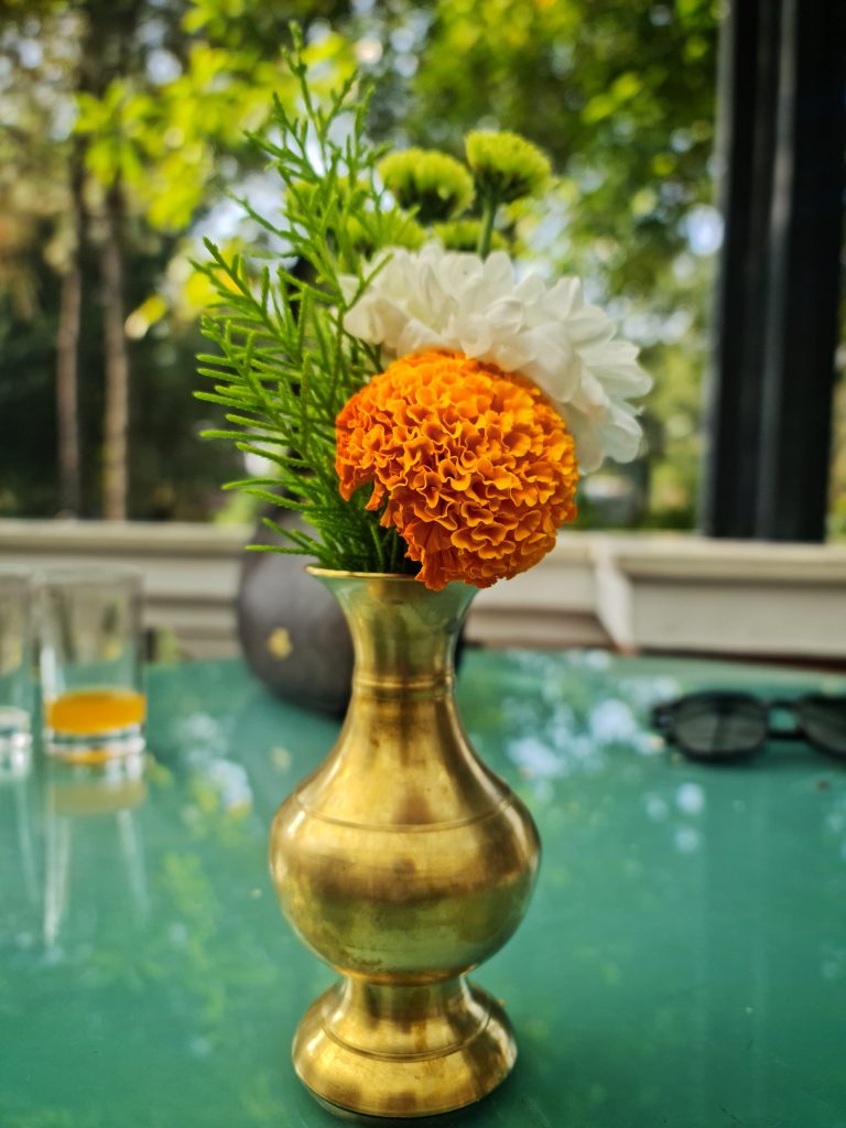 Small traditional pot containing a flower.