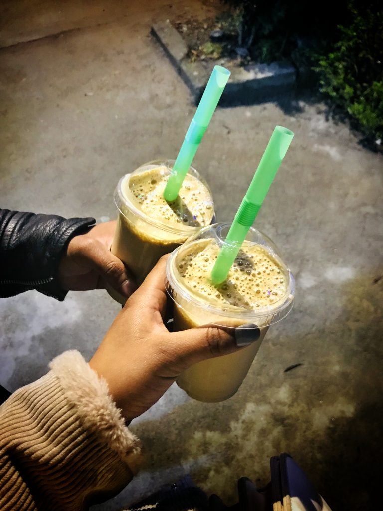 Two iced coffees, each with a straw.