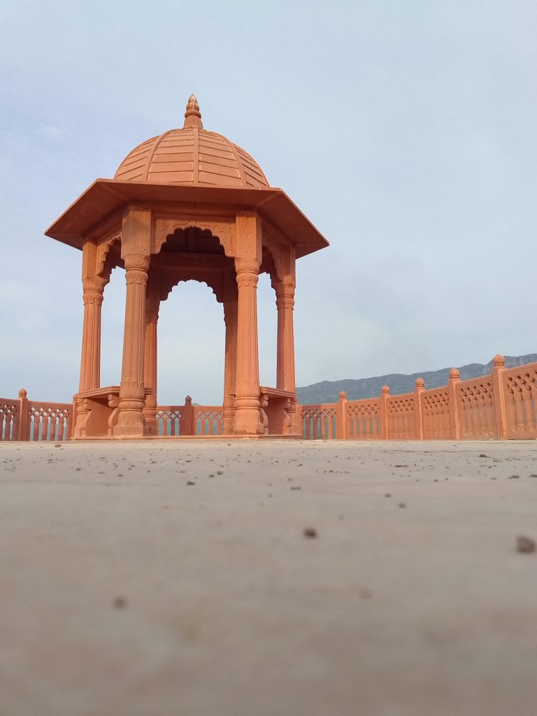 Enjoy the beautiful view of Foy Sagar Garden, with a lovely red structure adding charm to the scenic landscape.