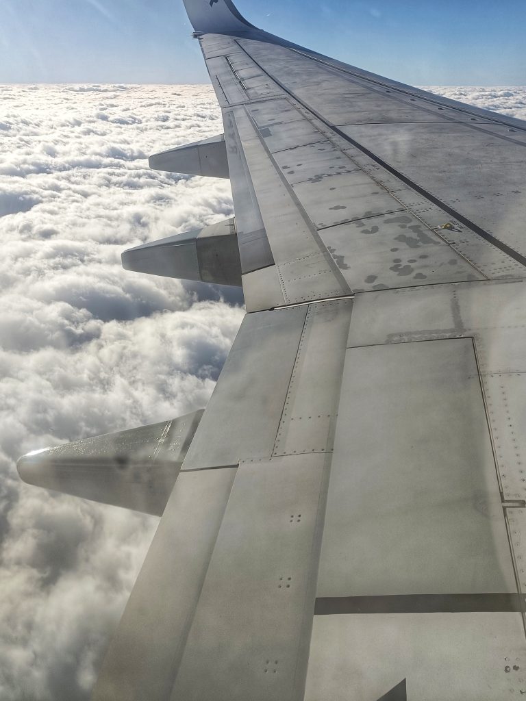 Plane wing over the clouds