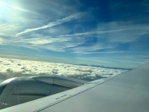 View of clouds and the blue sky through the airplane windows.