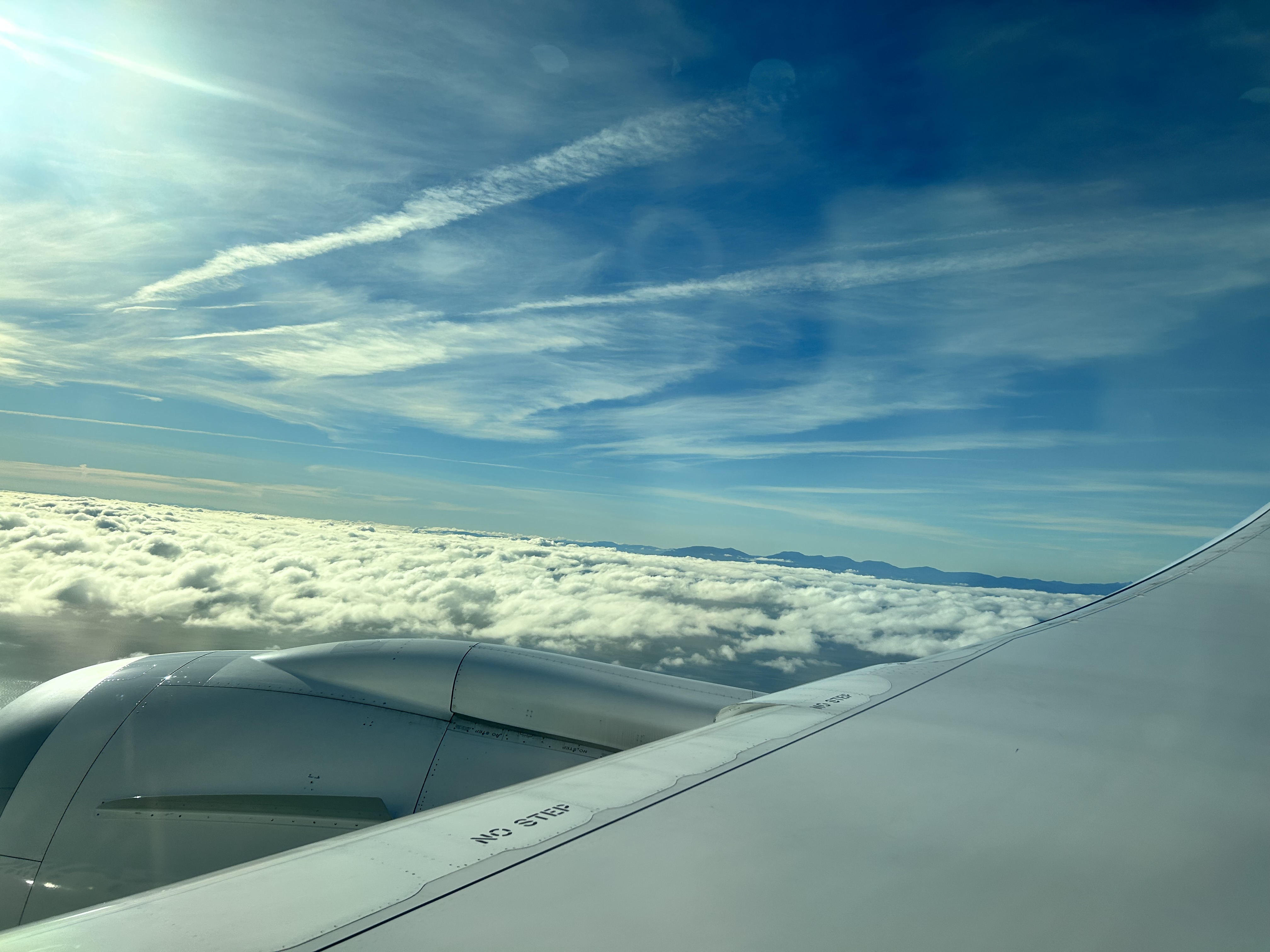 View of clouds and the blue sky through the airplane windows.