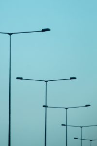 T-shaped street lights overlapping due to the compression of a telephoto lens 