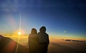 A couple enjoying the sunrise from the viewpoint at Peaky Peak.