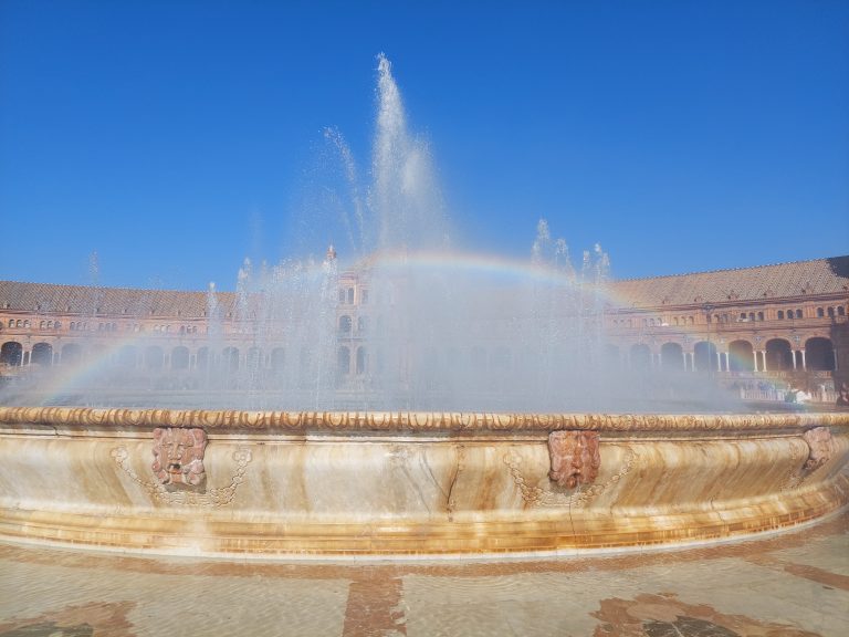 Rainbow over fountain. Sevilla, Spain