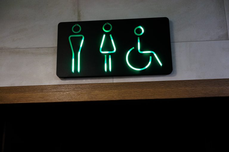 Green neon restrooms sign