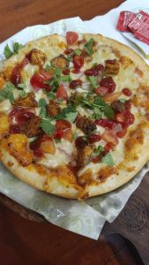 Close-up view of Double Cheese Butter Chicken Pizza