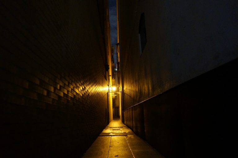 Narrow, dark street in the center of Seville