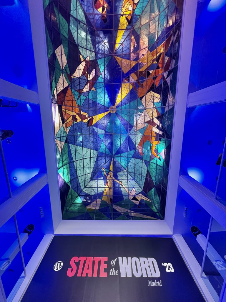 The venue for the State of the Word 2023 event in Madrid. This photo shows the “stained glass” ceiling of the venue.