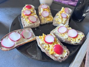 Fried egg on toast with cutting radishes pieces- Healthy breakfast