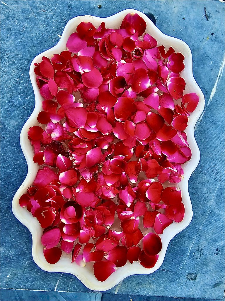 Rose petals in a marble bowl as a decoration.