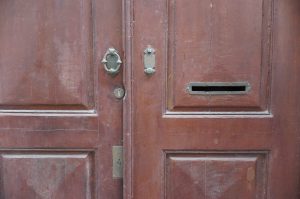 Old wooden door with brass accents and letterbox