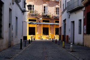 Bright yellow cafe at the end of a street