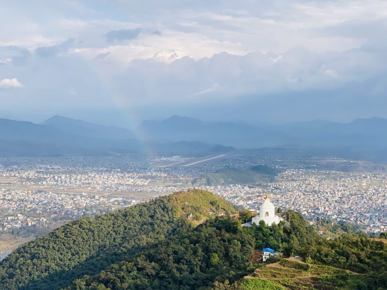 Bird’s-eye perspective of a Buddhist temple situated atop a hill.