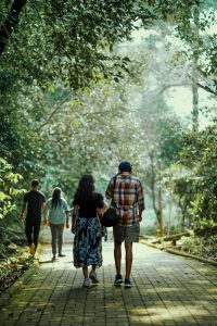 A Man and Women walking through a forest