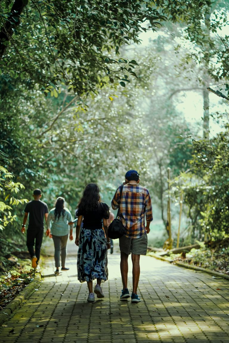 A Man and Women walking through a forest