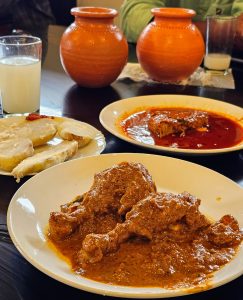 Chicken roast, boiled yam, fish curry, and chilled toddy. 