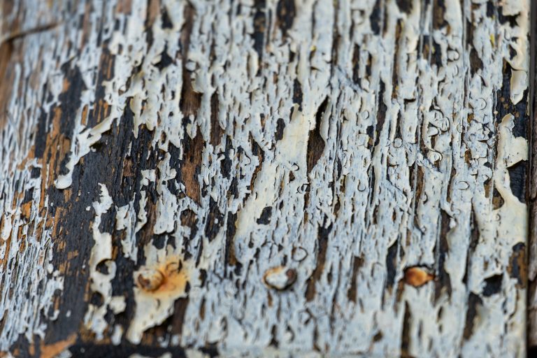 Paint peeling off of an old wooden table