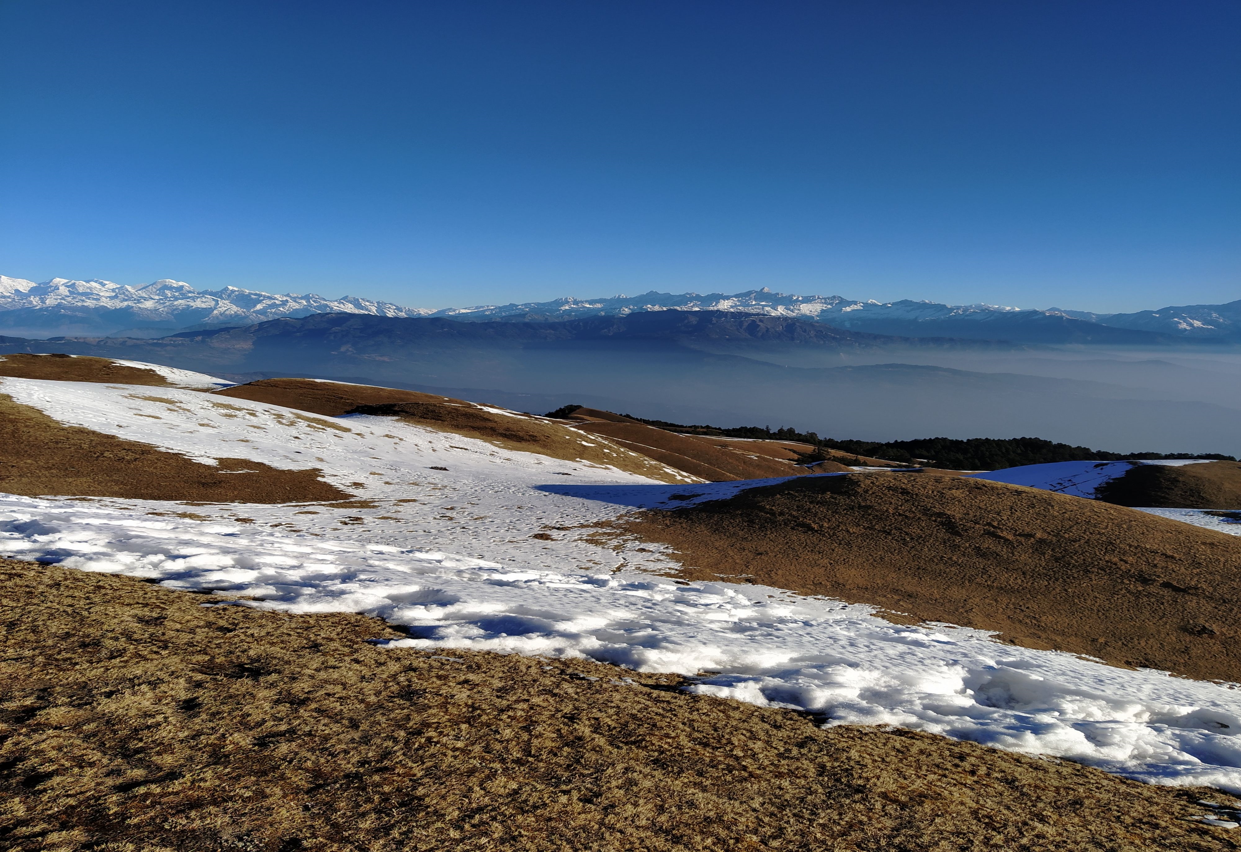 Scenic sight of majestic hills, snowy mountains, and natural surroundings.