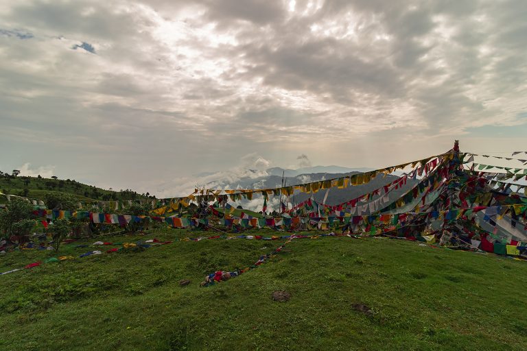 Prayer flags cris-cross on a mountain top during the morning at Chitrey, West Bengal.