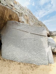 A stone with multiple dots. From the sites of Royal Enclosure and Pushkarani in Hampi, Karnataka.