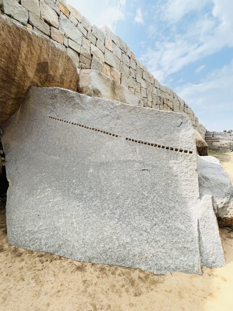 A stone with multiple dots. From the sites of Royal Enclosure and Pushkarani in Hampi, Karnataka.