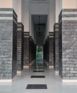 A corridor between an array of pillars. 