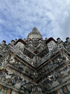 Looking up at the top of a prang at Wat Arun Ratchawararam Ratchawaramahawihan in Bangkok, Thailand from close up halfway up the monument at the highest climbable view point.