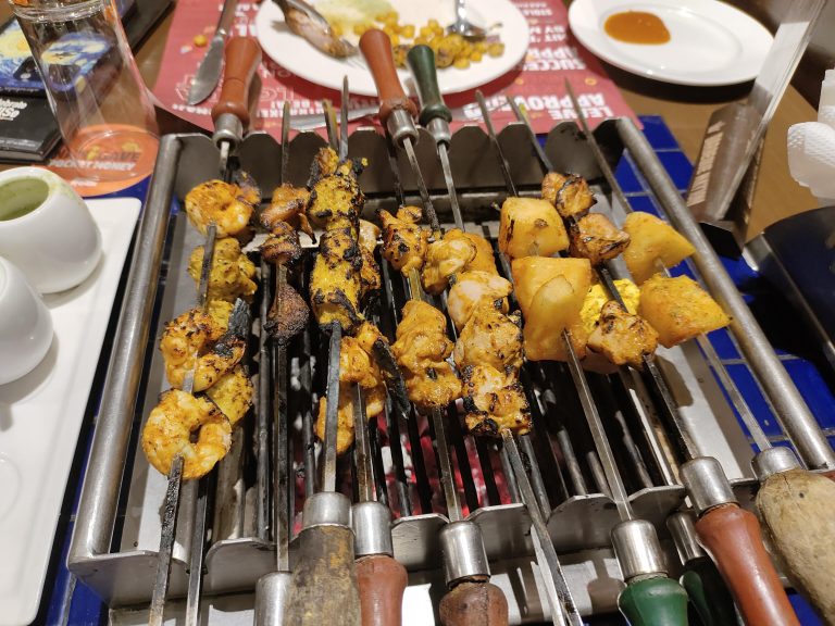 BBQ of meat and vegetables on a table.