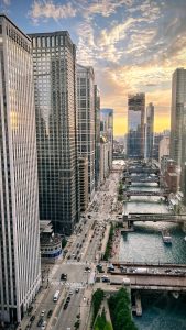 Chicago River and surrounding skyscrapers at sunset as viewed from the rooftop patio at The Royal Sonesta Chicago Downtown