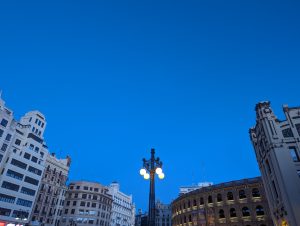 View larger photo: In Valencia, a clear scene unfolds with blue skies, buildings, and streetlights.