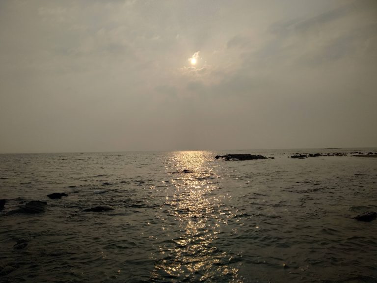 A sunny day at Saint Martin island, Bangladesh, with the ocean glistening under the sun.