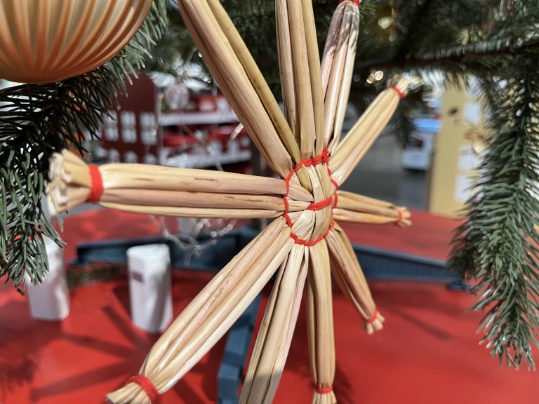 Christmas tree star made of straw and hand threaded together.