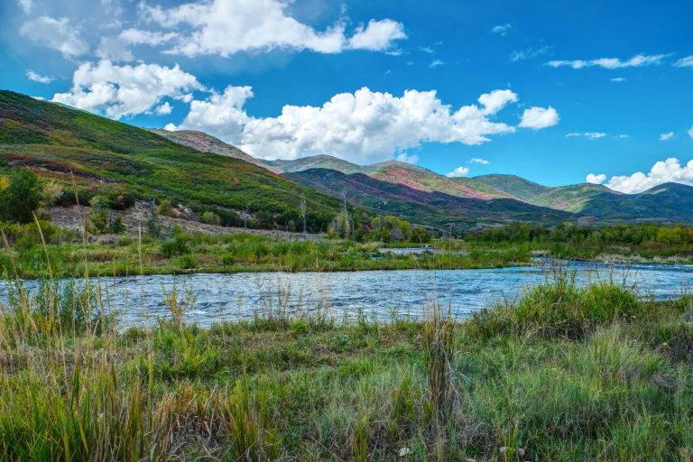 Some clouds hover over some hills alongside the provo river just outside of park city, utah.