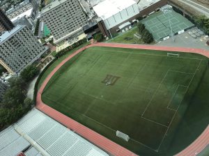 Empty Nickerson Field at Boston University, BU logo with Rhett at center surrounded by soccer and lacrosse lines.