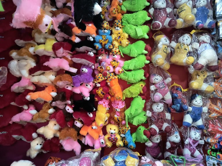 Plush menagerie in a whimsical teddy shop, showcasing diverse stuffed animals and birds with cotton.