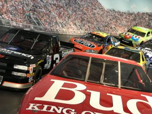 Several unoccupied NASCAR race cars in race formation facing the viewer on a race track display in the NASCAR Hall of Fame, in North Carolina, USA.