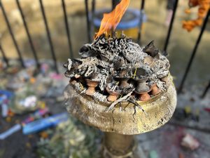 Lamps burning brightly on the side of a temple.

