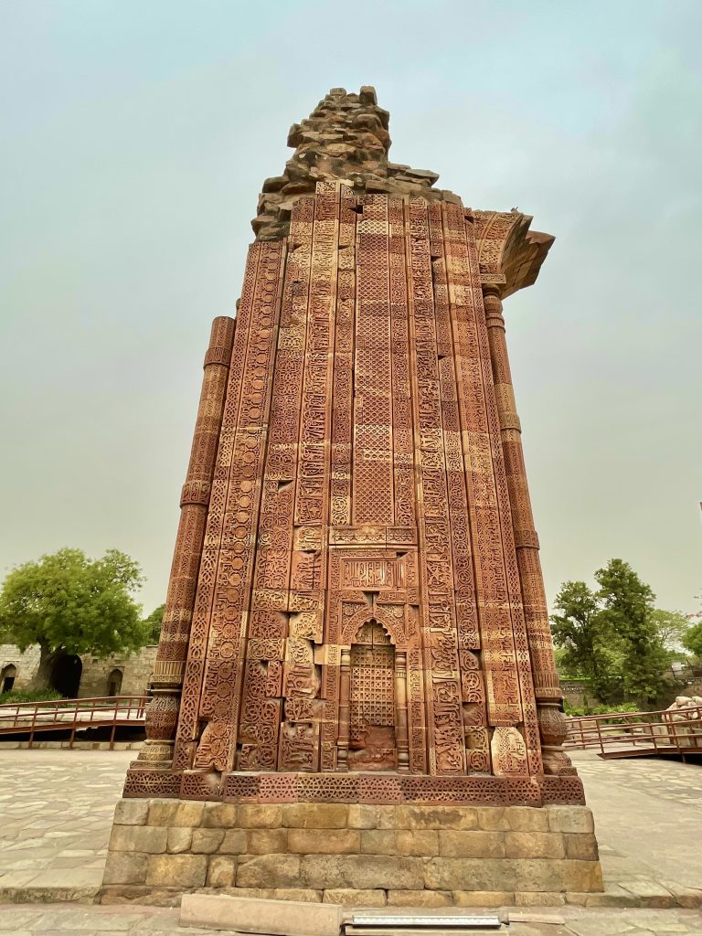 A broken red stone pillar with marvellous craving works. From Qutb complex, New Delhi.