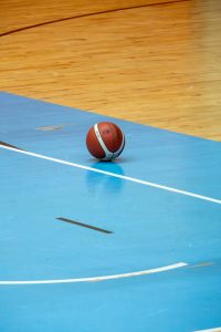 A basketball on the court's floor. 