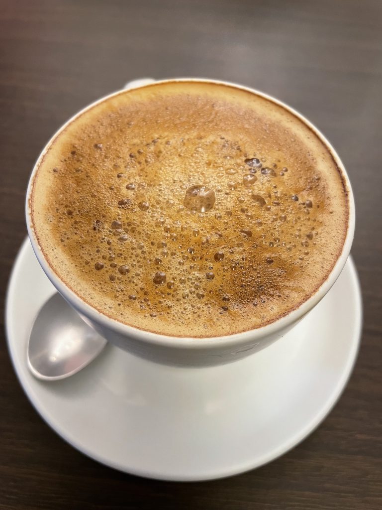 Filter coffee in a white cup, a closer view. From Kozhikode, Kerala.