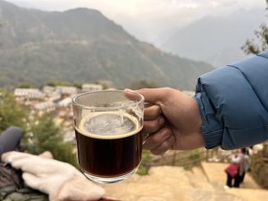 A coffee cup in a hand and beautiful village in the background! 