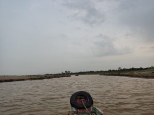 A river with vibrant waves in Sylhet, Bangladesh with a cloudy and smoky sky