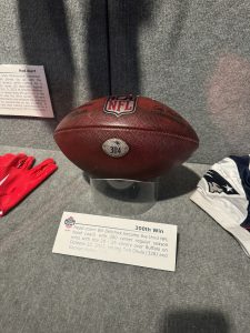 A football in a museum. The football was in a game of NFL football from the New England Patriots vs. the Buffalo Bills on October 22, 2023. The Patriots won giving Bill Belichick his 300th career win as a head coach.