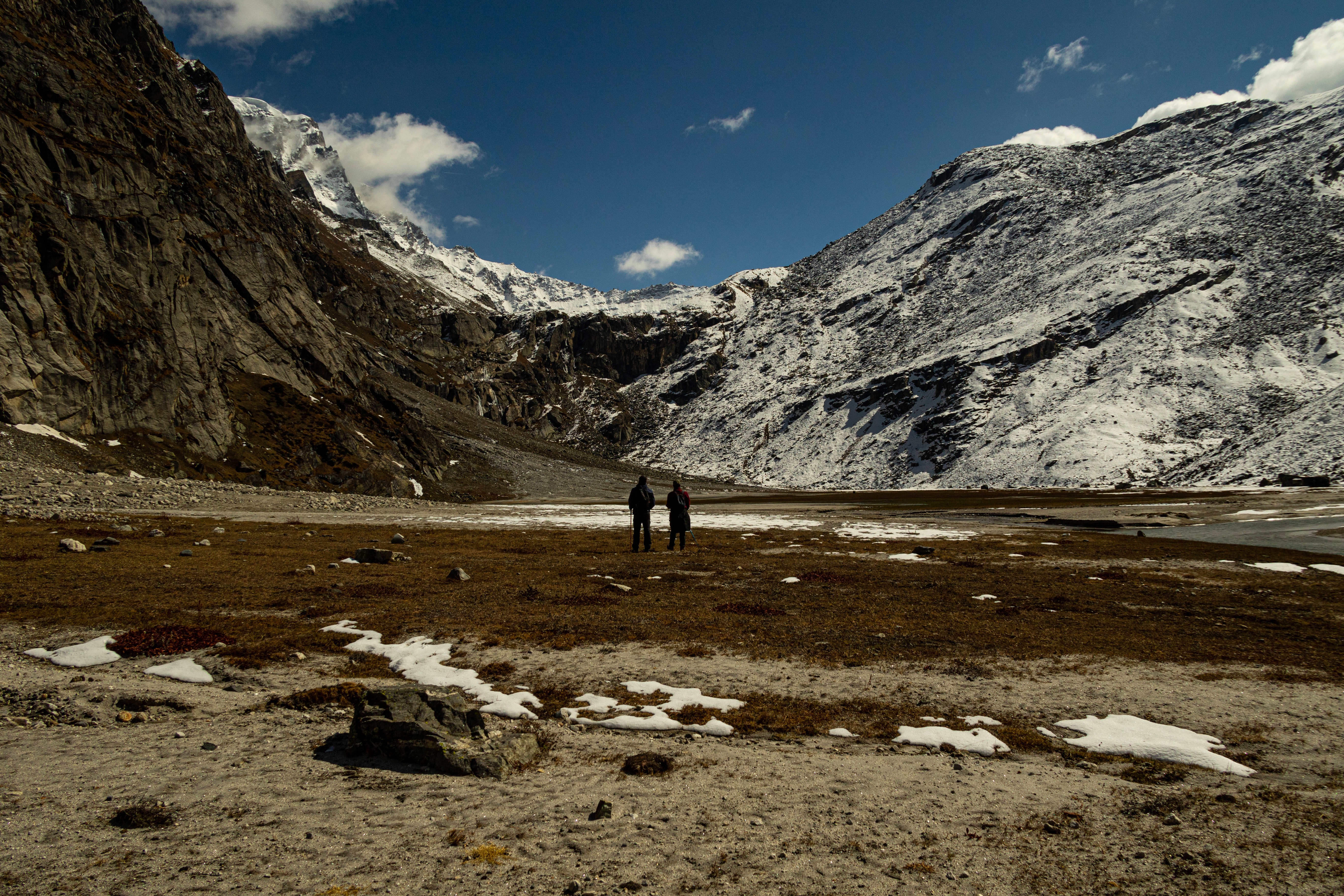 Two individuals delighting in the charming view of the Himalayan landscape.
