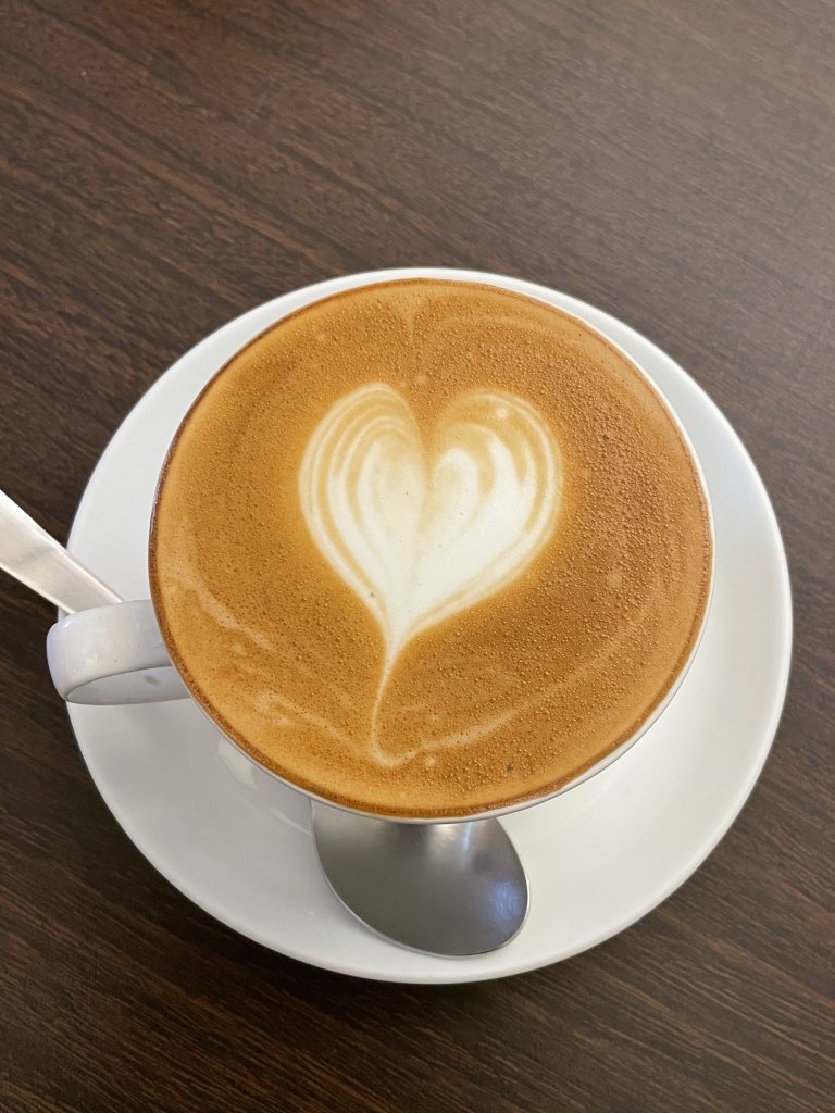 Cappuccino with a silver colour spoon. From Kozhikode, Kerala.