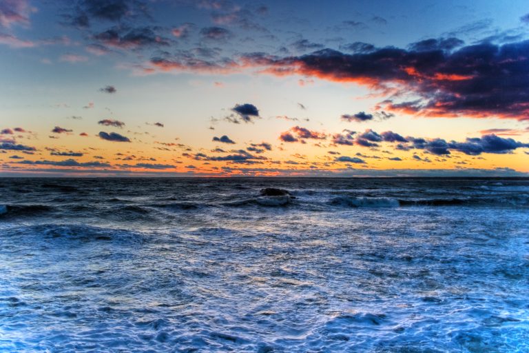 Waves swell as the sun sets over the Atlantic, after a storm has passed through New England.