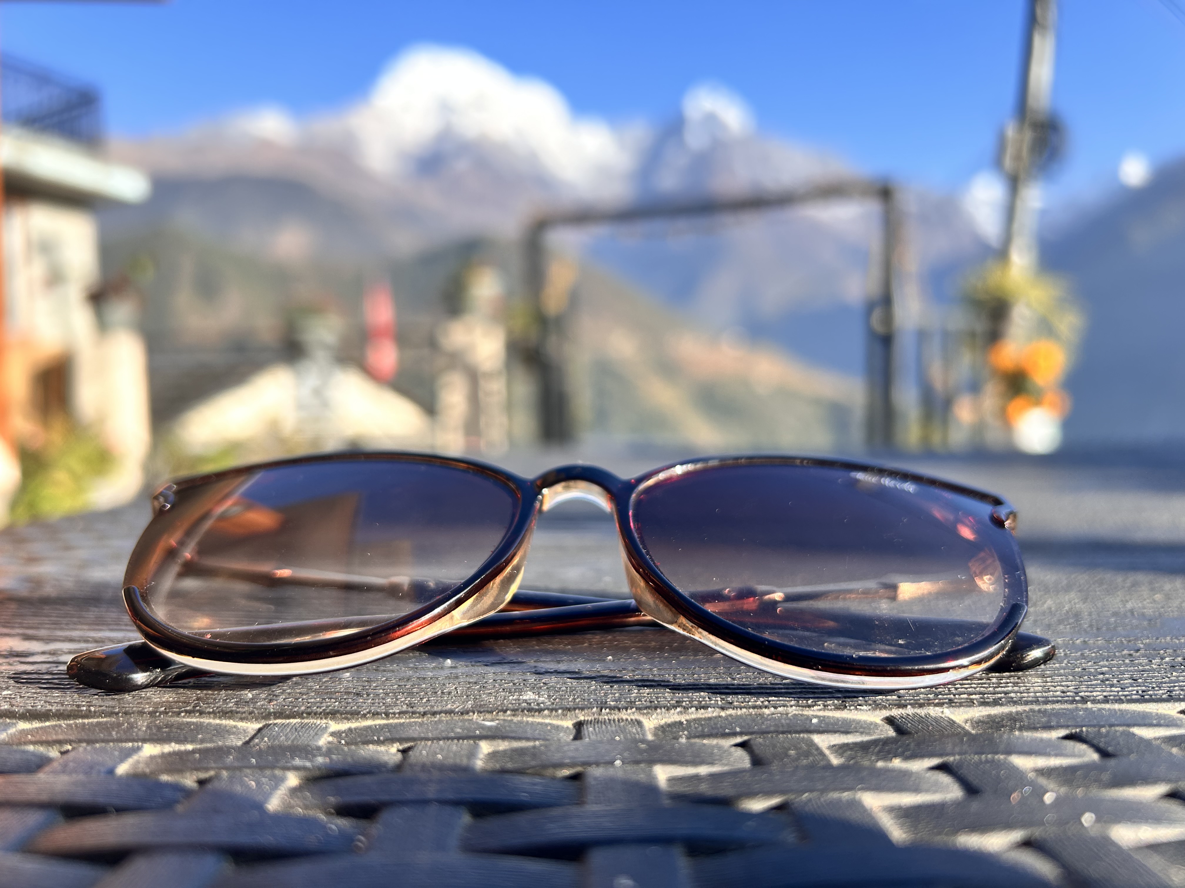 Black sunglasses set against a backdrop of snowy mountain serenity.