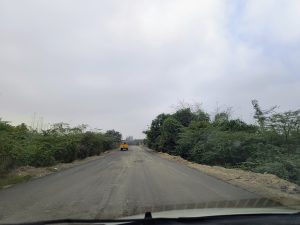 A road with a tractor driving down it