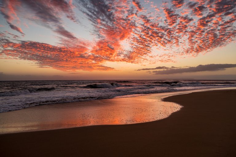 The sun sets over a beach in Kauai, Hawaii, USA